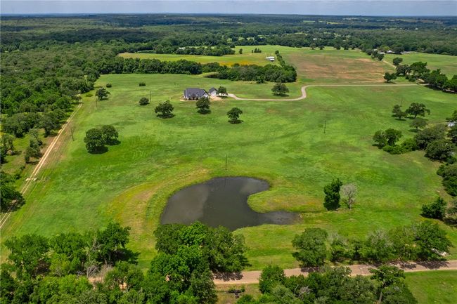 Aerial view of sparsely populated area featuring a nearby body of water | Image 34