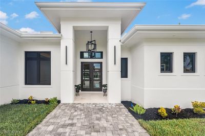 Elegantly covered entry with marble title and hurricane impact French doors | Image 3