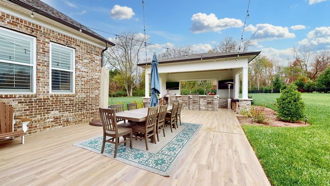 Step into paradise! Outdoor entertaining dreams start here—spacious patio, string lights, and a custom outdoor kitchen ready for your next gathering! | Image 55