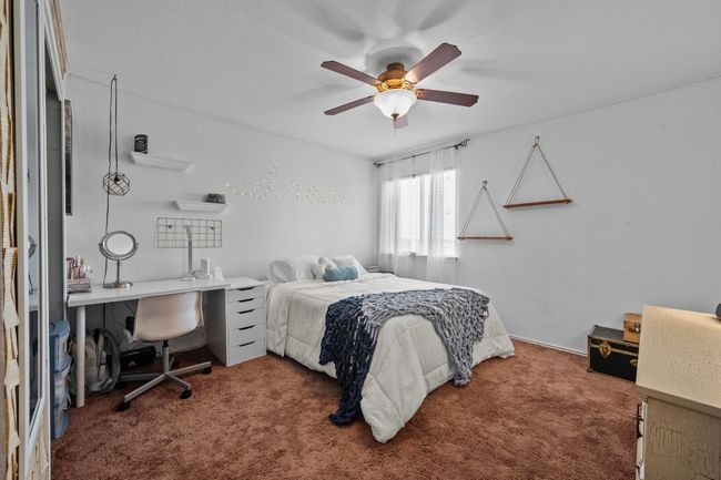 Another nice-sized bedroom with a ceiling fan and a walk-in closet. | Image 18