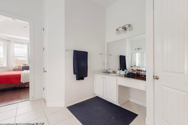 Ensuite bathroom with tile patterned flooring, ensuite bath, vanity, and baseboards | Image 16