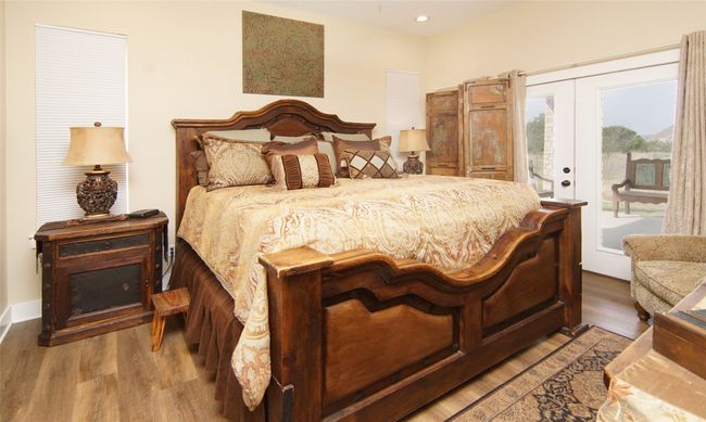 Bedroom featuring access to outside, wood finished floors, french doors, and recessed lighting | Image 14