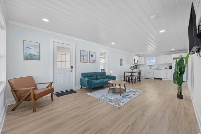 Living room with ornamental molding, light wood-type flooring, recessed lighting, and baseboards | Image 24