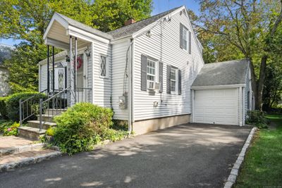 The home offers a one car garage and paved driveway. | Image 3