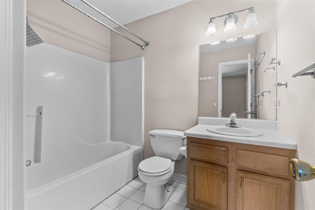 Full bathroom featuring toilet, vanity, tile patterned floors, and bathtub / shower combination | Image 23