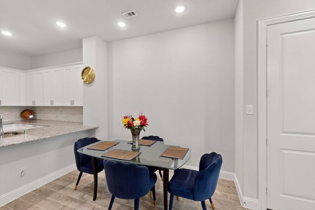Dining area with wood tiled floors and recessed lighting | Image 13
