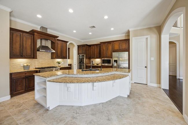 Lots of natural light flow through this stunning chef's kitchen with under cabinet lighting and custom storage cabinets throughout (fridge included) | Image 15