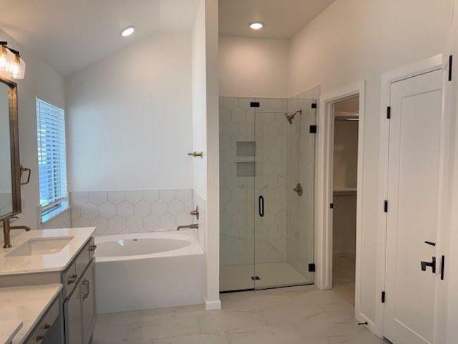 Full bathroom with lofted ceiling, a garden tub, a shower stall, and marble finish floor | Image 22