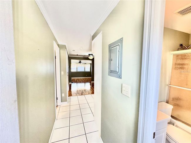 View from front door walking in. Bathroom on right, bedroom #1 on left and kitchen straight ahead first. | Image 4