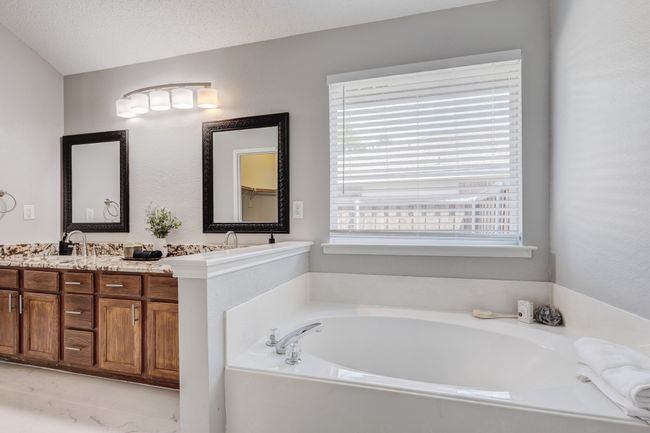 Full bath featuring a bath and double vanity | Image 26