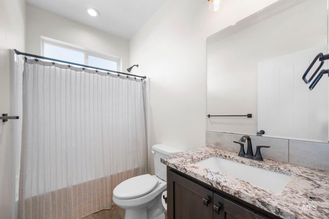 Full bath featuring vanity and shower / bathtub combination with curtain | Image 28