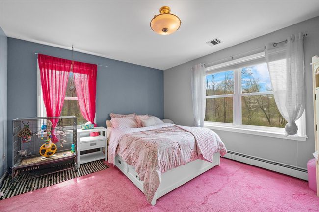 Carpeted bedroom with visible vents and a baseboard radiator | Image 24