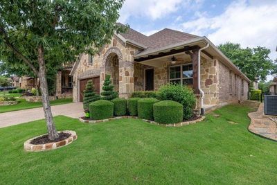 View of front facade with ceiling fan and a front lawn | Image 1