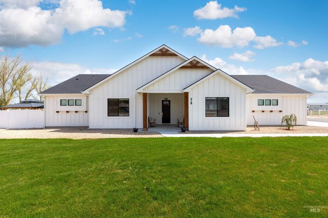 Modern farmhouse style home with board and batten siding and roof with shingles | Image 33