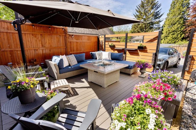 Deck with an outdoor living space with a fire pit and fence | Image 30