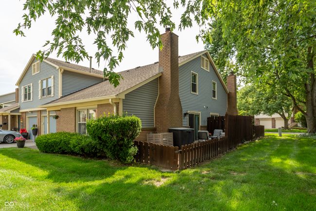 view of property exterior featuring a shingled roof, brick siding, and a chimney | Image 33