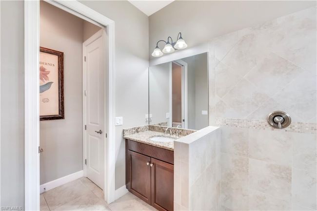 Bathroom with vanity, tile patterned floors, and a tile shower | Image 24