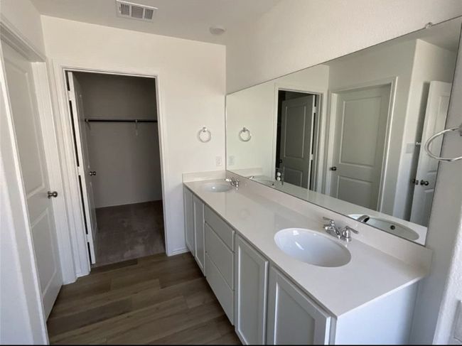 Full bathroom featuring wood finished floors, double vanity, and a spacious closet | Image 20