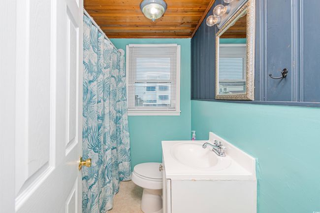 Bathroom featuring vanity, wood ceiling, and tile patterned floors | Image 34