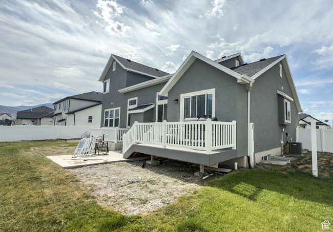 Back of property with a patio, a fenced backyard, a deck, stucco siding, and roof with shingles | Image 28