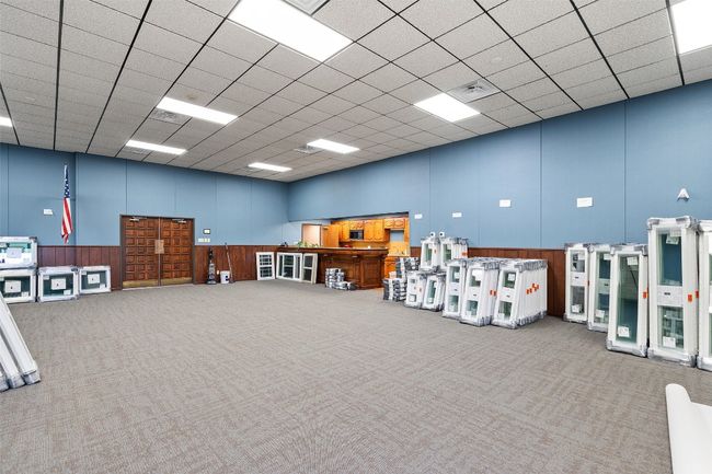 Conference room featuring a high ceiling, carpet flooring, a paneled ceiling, and full kitchen | Image 13