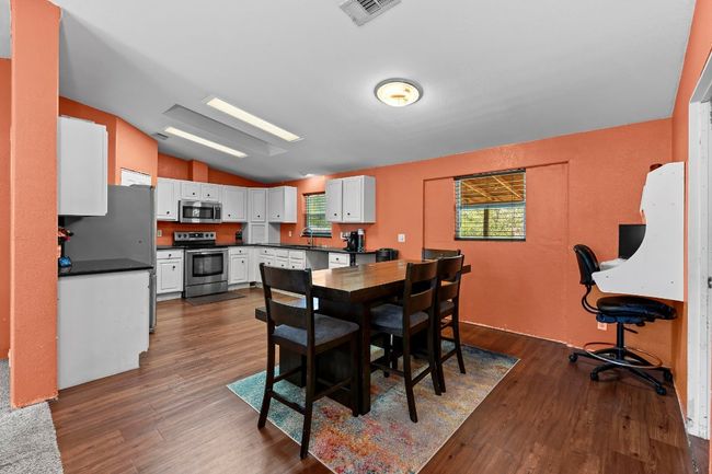 Dining space featuring lofted ceiling and wood-style flooring | Image 8