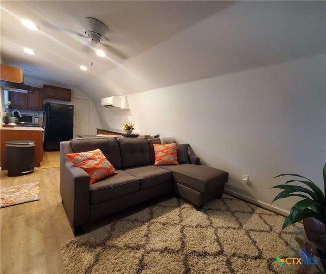 View shows living room with view to kitchen. | Image 13