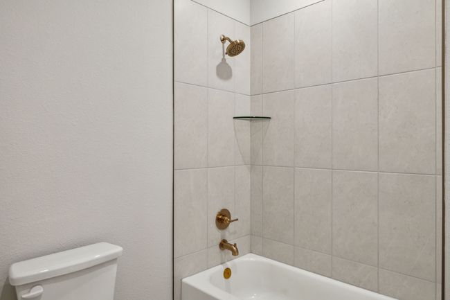 Bathroom featuring toilet and shower / tub combination | Image 23