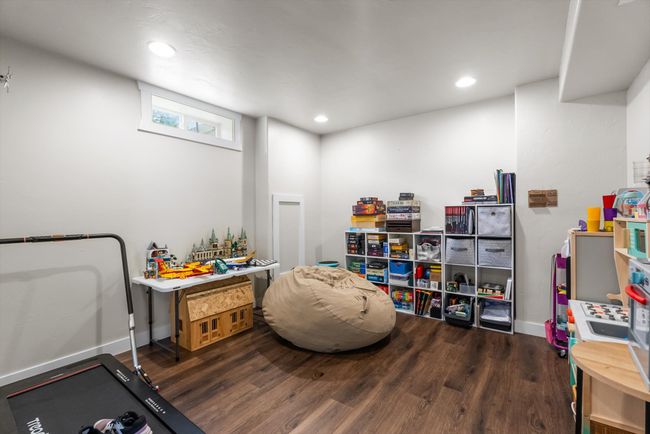 Fully finished basement featuring a gameroom featuring wood-look vinyl floors and recessed lighting | Image 26