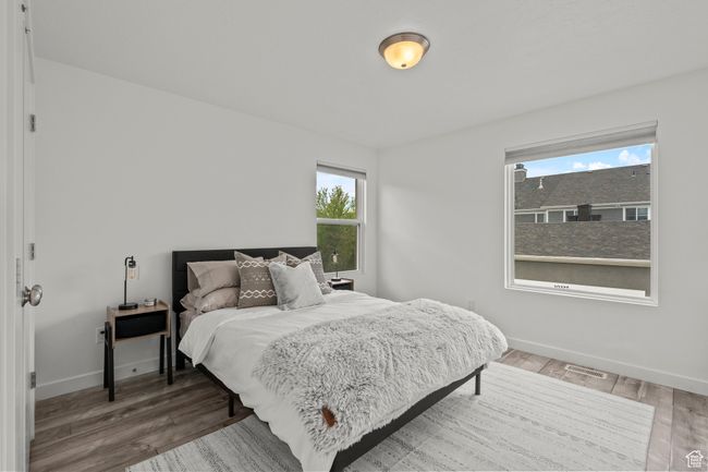 Bedroom 2 with multiple windows and wood finished floors | Image 32