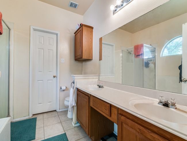 Full bath with a shower stall, visible vents, and a sink | Image 20