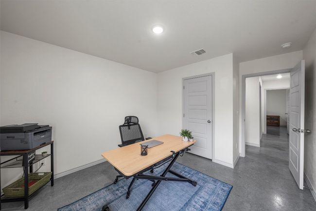 Office area featuring baseboards, visible vents, recessed lighting, and concrete flooring | Image 19