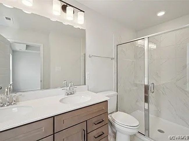 Full bath featuring double vanity, a marble finish shower, and recessed lighting | Image 28