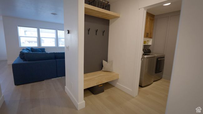 Functional Mudroom with Smart Storagefeatures a chunky light wood bench, upper shelf, plenty of hooks for coats and bags, and space below for baskets or shoes. Stylish and practical! | Image 26