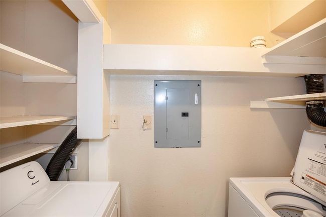 Just beyond the kitchen, the utility area offers easy access to full size washer and dryer with extra storage. | Image 21
