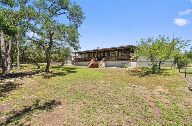 Rear view of house featuring a yard, stairs, and covered porch | Image 7