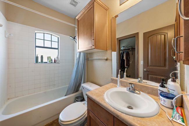 Full bath featuring vanity and shower / bath combination with curtain | Image 17