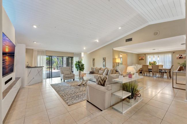 Formal Living room has passage to family room and sliders to patio with water views. | Image 7