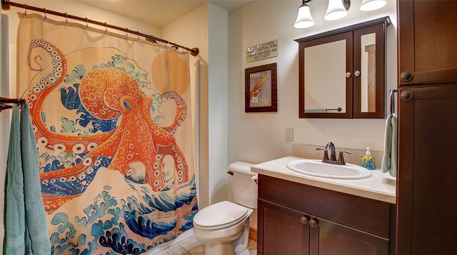 Bathroom featuring vanity, toilet, tile patterned floors, and a shower with curtain | Image 27