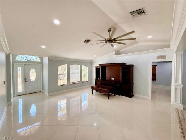 Entrance foyer with baseboards, visible vents, and crown molding | Image 5