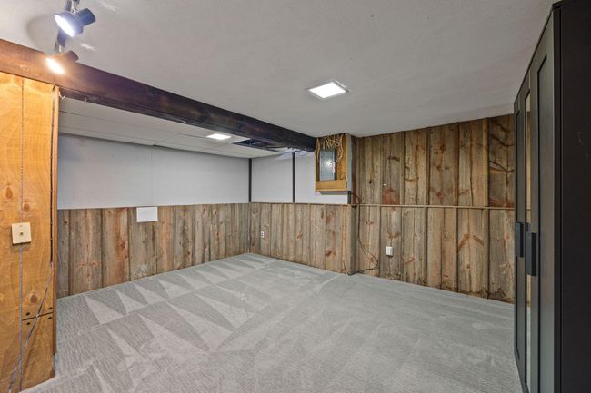 Lower level provides a spacious office or hobby room. | Image 11