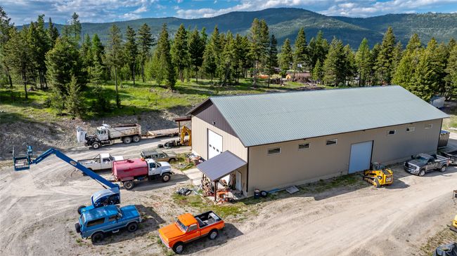 Aerial view of property and surrounding area with mountains and a heavily wooded area | Image 79