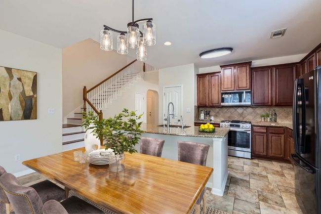Showing digitally staged kitchen/dining area | Image 8