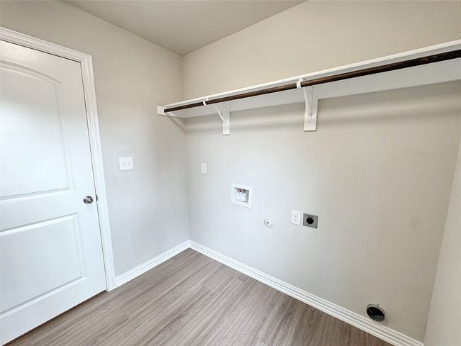 Laundry area with electric dryer hookup, light wood-style floors, hookup for a washing machine, and hookup for a gas dryer | Image 15