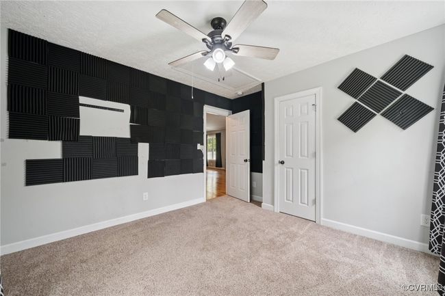 Unfurnished bedroom with carpet flooring, baseboards, a ceiling fan, and attic access | Image 23