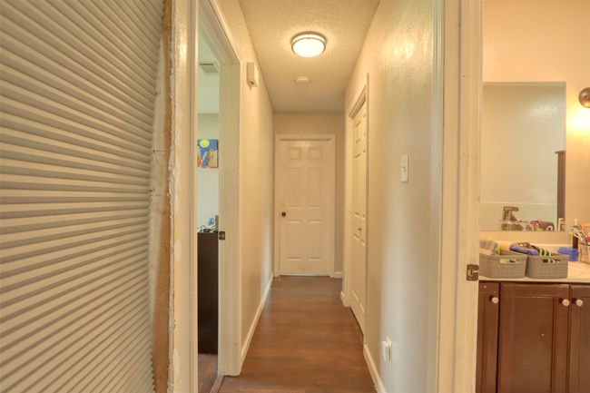 Corridor featuring dark wood-style flooring and baseboards | Image 27