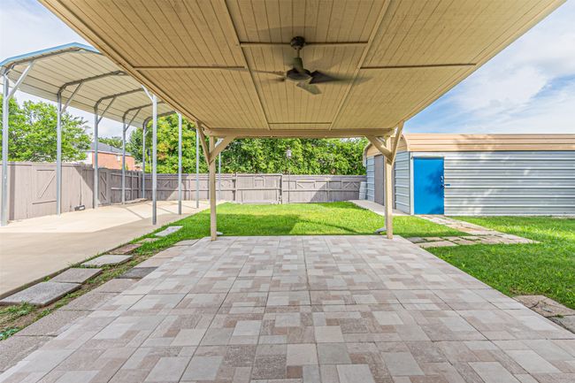 Fenced backyard featuring a patio area and a ceiling fan | Image 29