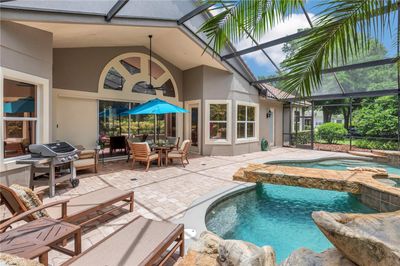 Gorgeous Lagoon style screened pool and spa with Paver deck and covered Lanai | Image 3