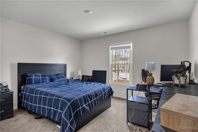 Carpeted bedroom featuring baseboards and visible vents | Image 16