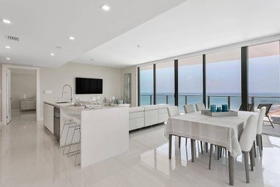 Floor to ceiling windows with panoramic views of ocean & night city skyline | Image 2